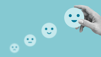 Mental health and positive thinking and growth mindset. Recovery to happiness emotion. Rating to service experience on online application. Hand choosing happy smiley face