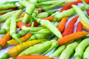 Background of Heap of fresh Bird's eye chilli  Thai chili pepper or Capsicum frutescens, green, red and yellow colors.