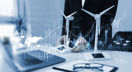 Turbines with graph and rising arrows.Businessman making development plan profits with business wind turbines and solar panels.Increase in electricity prices.Green electrical energy is growing