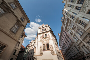 Narrow street with colorful historical buildings leading to hotel Prague