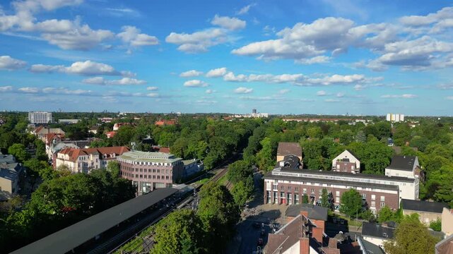 berlin zehlendorf suburb showing buildings and s bahn train station on a sunny summer day. Nice aerial view flight descending drone