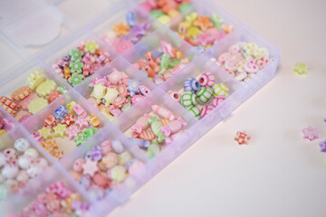 Making handmade beaded jewelry in workplace. Fashion, creativity, bracelets with beads and stones. Handmade jewelry, small business, hobby concept.