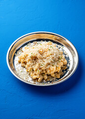 Truffle Mac and Cheese creamy macaroni served in plated isolated on blue background closeup side view of italian food