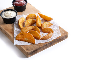 Fried potato wedges isolated on white background. Copy space