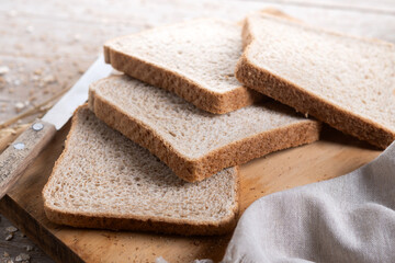 Healthy wholemeal bread slices on wooden table