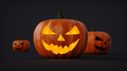 Three halloween pumpkins  on dark background 