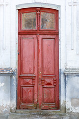 Old traditional painted wooden door with handle. Ancient closed wooden front door. Vertical photo
