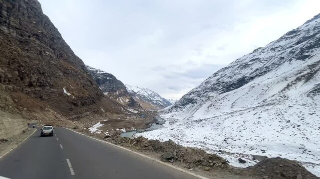 MANALI, INDIA - January 9, 2024: Atal Tunnel Indian highway tunnel built under the Rohtang Pass in Himalayas.Snow mountains landscape.Winter ride between snow mountains in Manali Himachal Pradesh.