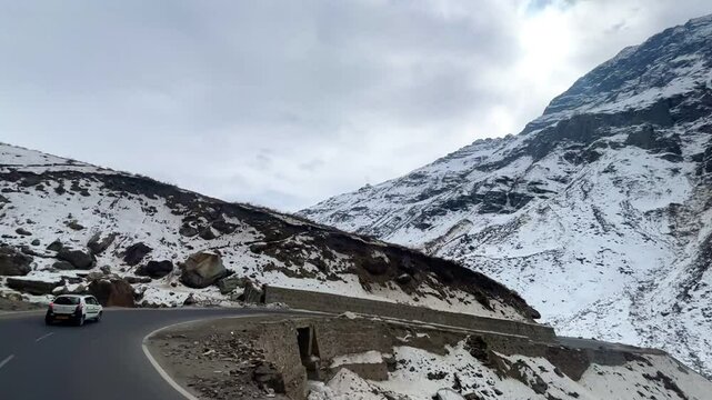 MANALI, INDIA - January 9, 2024: Atal Tunnel Indian highway tunnel built under the Rohtang Pass in Himalayas.Snow mountains landscape.Winter ride between snow mountains in Manali Himachal Pradesh.