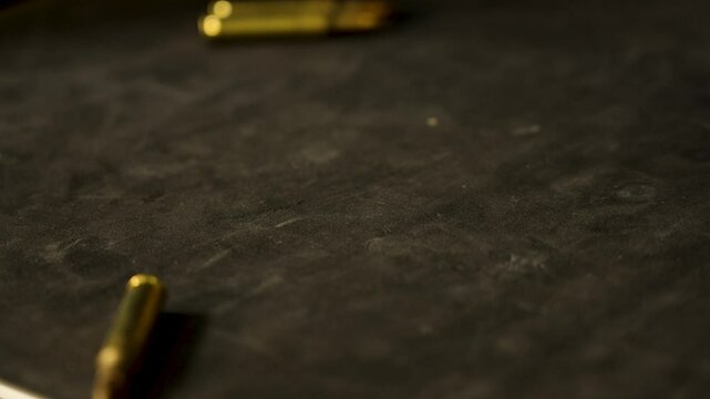 Across the frame, rounds of 5.56 roll.