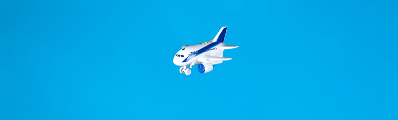 toy airplane flies in cotton wool clouds