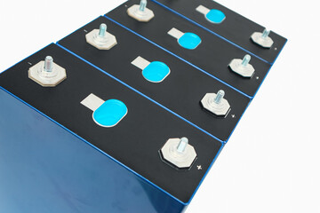 Row of LiFePo4 cells on white background. Prismatic modules for lithium iron phosphate battery....