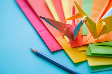 Colorful origami paper cranes with pencil, generative AI concept