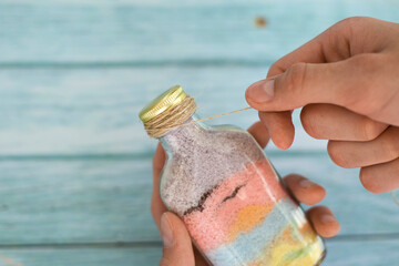 Step by step. Home made decorative sand picture in a bottle. Step 7 from 8.