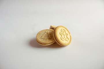 Round cookies with including Christmas symbols such as trees, snowmen and other holiday characters. Vanilla or butter sandwich cookies.
