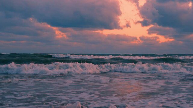 Beautiful Foaming Waves in the Ocean Colorful Orange Sky Purple Clouds Beach Time Lapse. Sea Waves Colored Clody Sunset Sky Timelapse, Beauty Vacation Travel Planet Nobody Journey.