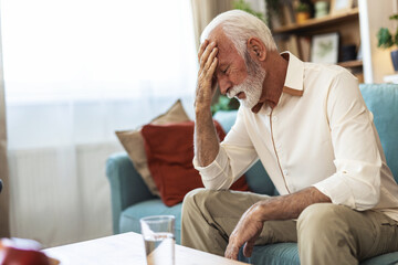 Senior, man and pain from headache in home with stress, frustrated or confused from brain fog in...