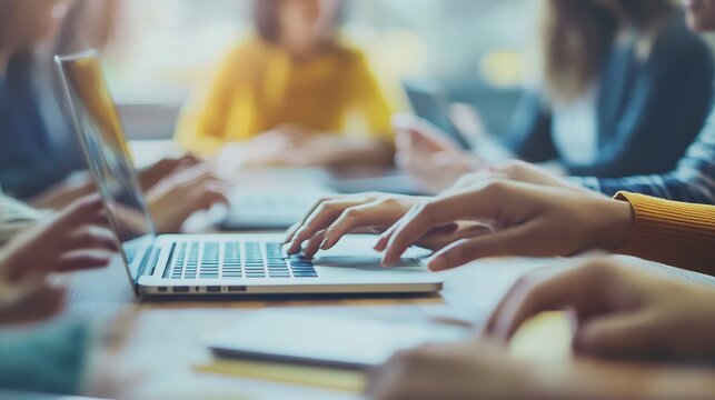 Multicultural Creative Colleagues Discussing a New Business Opportunity, Talking in an Office Meeting Room, Using Laptop Computer. Close Up on Hands of Team Members. - Powered by Adobe