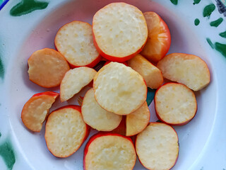 Fresh ripe of cashew fruit slices. Slice of cashew apple on a plate.
