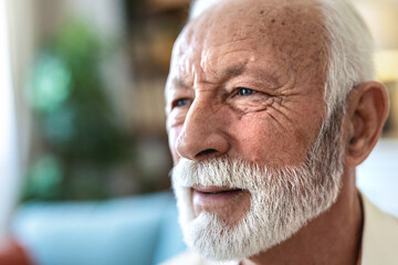 Dementia, eyes or nostalgia with senior man in retirement home for idea, memory or thinking. Anxiety, eyesight and mental health with elderly person in living room of apartment for planning or vision.