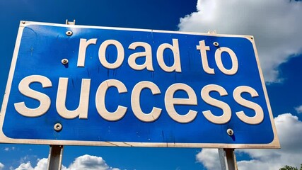 A colorful sign points the way to success, set against a backdrop of a clear blue sky and fluffy clouds