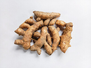White turmeric on white background. White turmeric or Kunyit putih (Curcuma zedoaria). Fresh turmeric roots. Herb and medicinal plants. Flat lay. Top view.