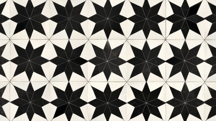 Fototapeta premium Symmetrical star shapes in black and white, arranged in a repeating pattern that creates a bold, graphic tile design.
