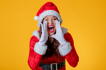 young woman wearing santa claus suit isolated screaming