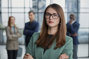Fototapeta premium Portrait of a confident young businesswoman standing with her arms crossed in an office