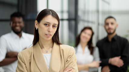 Confident businesswoman posing while looking at camera in front of office