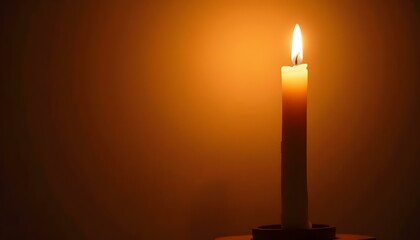 A solitary candle flickers softly, providing a gentle light that enhances the evening ambiance