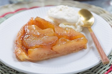 Slice of caramelized apple Tart Tartin with whipped cream, french upside down cake, horizontal