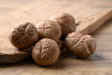 Fresh shiitake mushroom on wooden background, edible mushroom and food ingredient in Asian cuisine