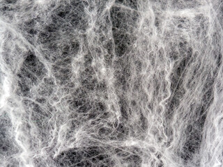 Realistic white threads of spider web on black background