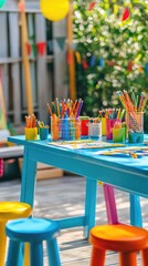 A colorful outdoor art station with vibrant stools and plenty of art supplies, perfect for encouraging children's creativity.