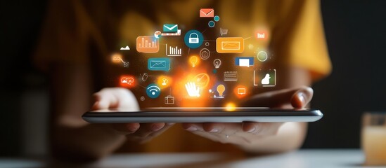 Person holding a tablet with glowing social media icons floating