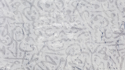 Arabic calligraphy wallpaper on a white wall with a black interlocking background subtitles...