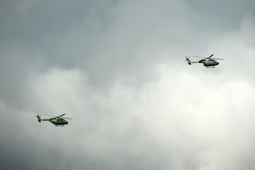 Helicopter is flying on isolated overcast mid-air sky