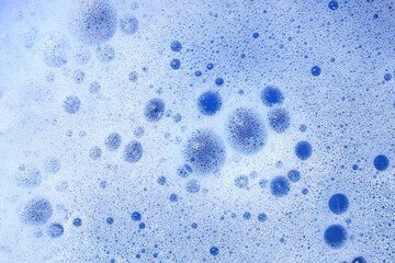 Soapy foam texture with bubbles as blue abstract backgrounds