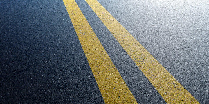 Cracked asphalt road with bright yellow parallel lines