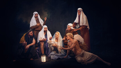 Biblical nativity scene showing Mary, baby Jesus and shepherds with angel. Peaceful representation...