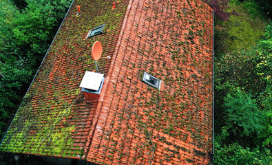 Drone capturing aerial view of mossy roof in need of cleaning