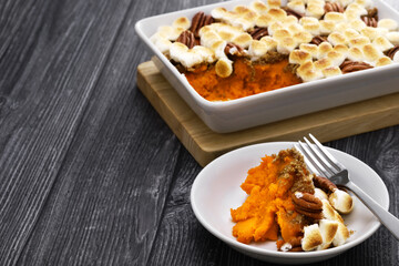 sweet potato casserole with marshmallows and pecans.  American thanksgiving dinner side dish.
