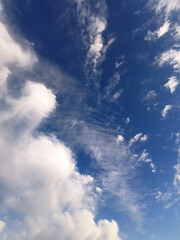 Color photography of blue sky with clouds. White clouds on blue sky. Beautiful summer photography of clear blue sky with white clouds, fresh air.