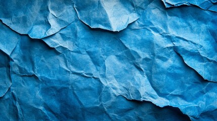 Obraz premium A close-up of a crumpled blue paper, creating a textured abstract background.