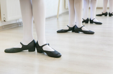 feet in black dancing shoes are standing on the dance floor, classic