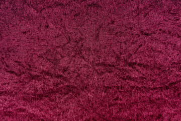 Rich deep burgundy red velvet fabric texture with soft, plush pile