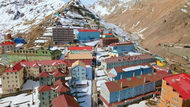 Drone Fly Colorful houses, Mining Town of Sewell in the Chilean Cordillera snowy Andean peaks