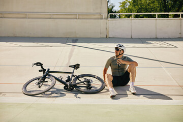 Sportsman resting enjoying refreshing time during cycling training