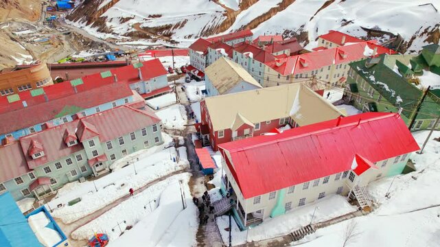 Drone fly old Mining Town of Sewell, Chilean Andes Cordillera Aerial view, snowy peaks and colorful residential houses